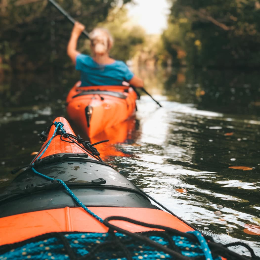 Two people kayaking in Bend, Oregon on the Deschutes River.
